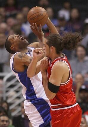 Clippers' Marcus Camby, left, is fouled by Joakim Noah of the Chicago Bulls during the first half Wednesday at Staples Center.