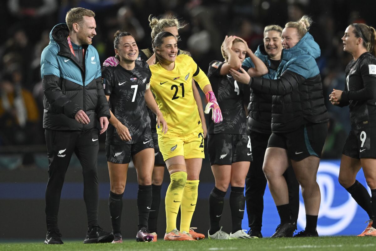New Zealand's Ali Riley, second left, celebrates with goalkeeper Victoria Esson after a win over Norway.
