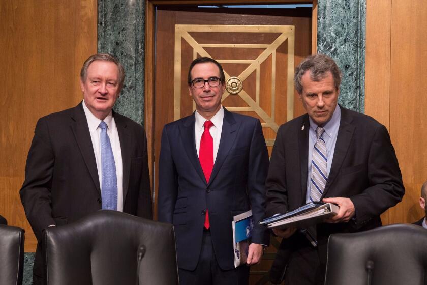 WASHINGTON, DC - MAY 18: (L) U.S. Sen. Sen. Mike Crapo (R-ID) , (C) Treasury Secretary Steven Mnuchin and (R) U.S. Sen. Sherrod Campbell Brown (D-OH) before speaking at a Senate Banking Committee and International Policy hearing on Capital Hill May 18, 2017 in Washington, DC. Mnuchin spoke before the committee that oversees bank regulations in his first congressional testimony since being named as Treasury secretary. (Photo by Tasos Katopodis/Getty Images) ** OUTS - ELSENT, FPG, CM - OUTS * NM, PH, VA if sourced by CT, LA or MoD **