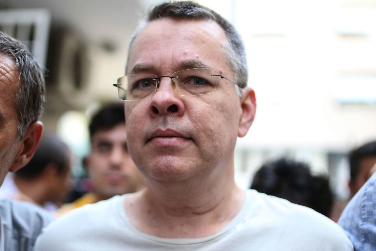 U.S. pastor Andrew Craig Brunson is escorted by Turkish plainclothes police officers from his house in Izmir, Turkey, on July 25.