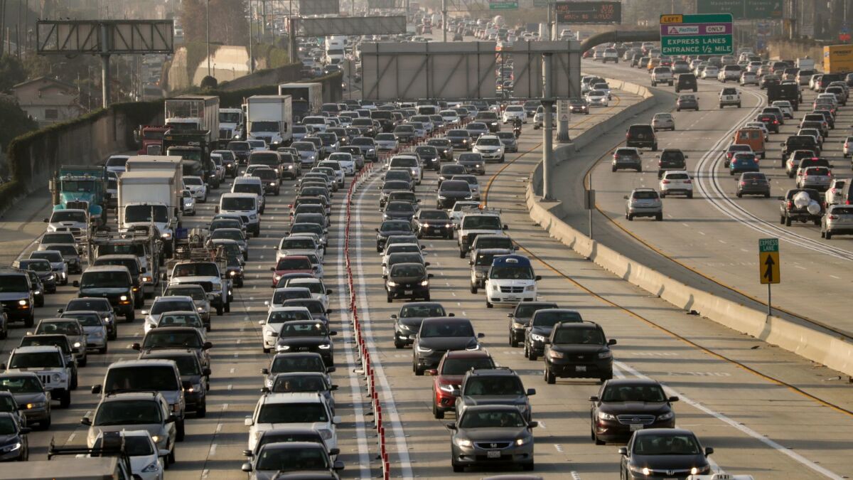 Traffic clogs the 105 Freeway on a day last fall. Southern Californians have been on a car-buying binge, contributing to a decline in transit ridership, a UCLA study has found.