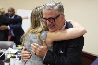 Actor Alec Baldwin hugs a member of his legal team after the judge threw out the involuntary manslaughter case for the 2021 fatal shooting of cinematographer Halyna Hutchins during filming of the Western movie "Rust," Friday, July 12, 2024, in Santa Fe, N.M. (Ramsay de Give/Pool Photo via AP)