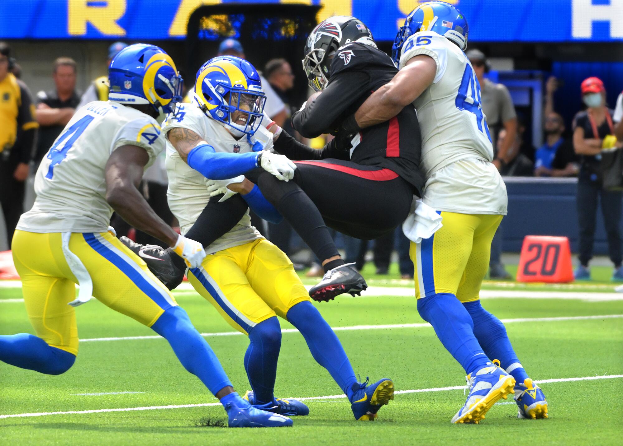 Rams defenders  Jordan Fuller, Cobie Durant and Bobby Wagner take down Falcons receiver Drake London.