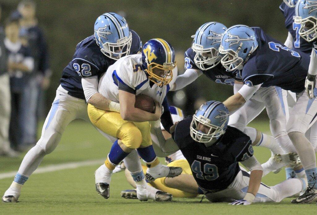 Corona del Mar High's Robby Hoffman (49) and Hugh Crance (22) tackle Nordhoff's Matt Woodcock during the first half in the CIF State Southern California Regional Division III Bowl Game at LeBard Stadium in Costa Mesa on Saturday.