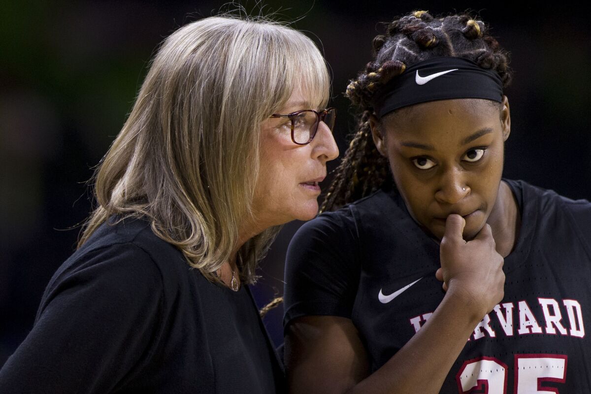 FILE - Harvard head coach Kathy Delaney-Smith, left, talks to Sydney Skinner (25) during the first half of an NCAA college basketball game against Notre Dame, Friday, Nov. 9, 2018, in South Bend, Ind. Coach Delaney-Smith is retiring after 40 years as Harvard's women's basketball coach, at the end of the 2021-2022 season. (AP Photo/Robert Franklin, File)