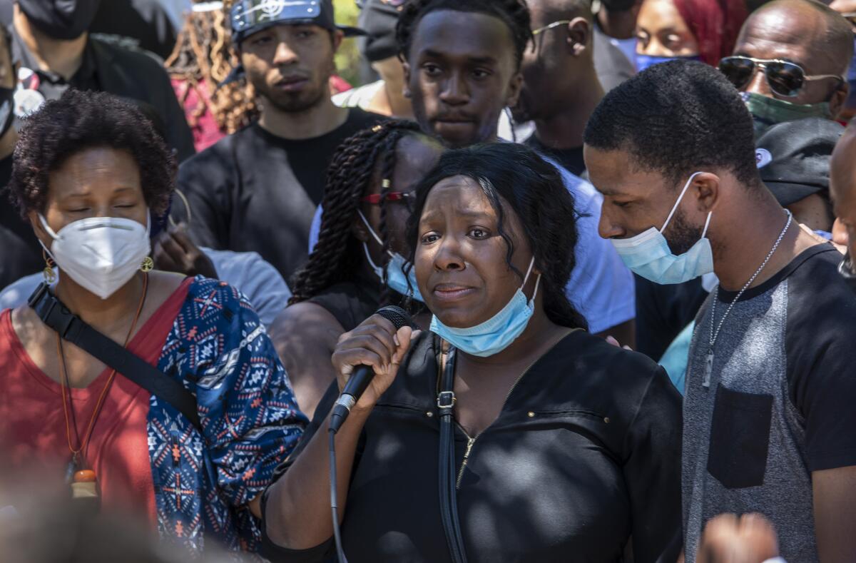 Diamond Alexander, center, joins demonstrators in Palmdale on Saturday to demand answers in her brother's death.