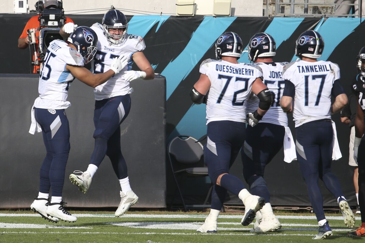 Tennessee Titans tight end Geoff Swaim, second from left, celebrates his touchdown reception against the Jacksonville Jaguars with teammates during the second half of an NFL football game, Sunday, Dec. 13, 2020, in Jacksonville, Fla. (AP Photo/Stephen B. Morton)