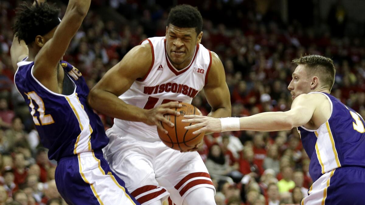 Wisconsin's Charlie Thomas tries to muscle his way past two Western Illinois defenders Friday night.