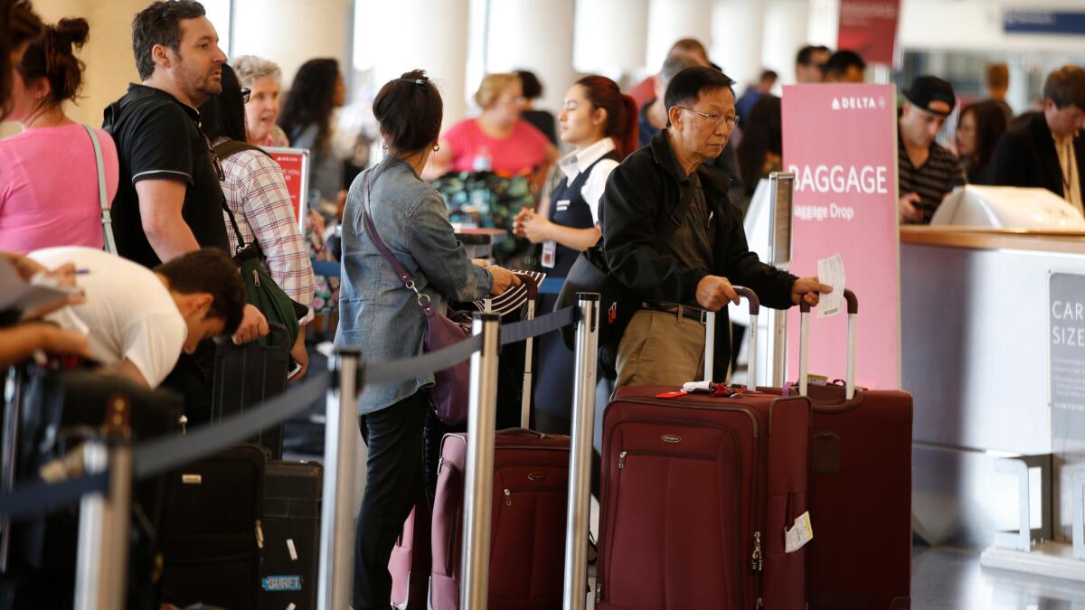Travelers wait in long lines at Los Angeles International Airport for their Labor Day getaways in 2015. Airline representatives predicted a 4% increase in fliers for this year's holiday.