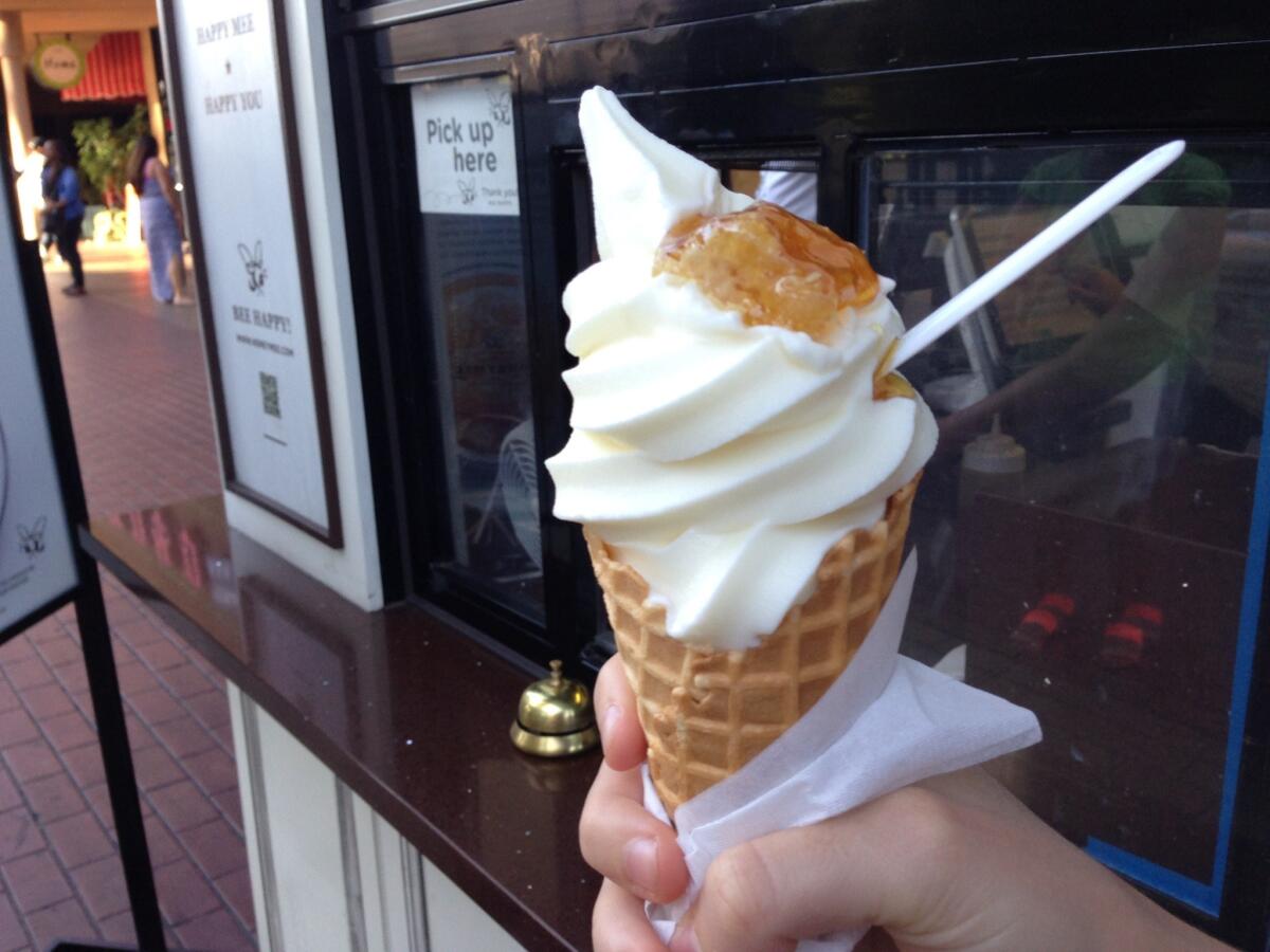 A cone of Honeymee's milk ice cream and honeycomb.
