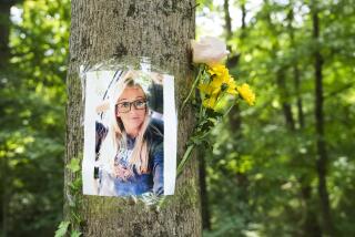 Baltimore, MD, 08/11/2023--The loved ones of Rachel Morin taped photos of her to trees and laid flowers on the grounds of the Ma and Pa Trail where she was found deceased. (MANDATORY CREDIT: Kaitlin Newman / The Baltimore Banner)