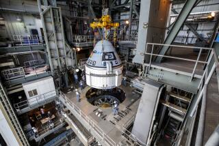 In this Nov. 21, 2019 photo provided by NASA, the Boeing CST-100 Starliner spacecraft is guided into position above a United Launch Alliance Atlas V rocket at the Vertical Integration Facility at Space Launch Complex 41 at Florida’s Cape Canaveral Air Force Station. Boeing has delayed its first test flight of its Starliner crew capsule to the International Space Station. The launch is now targeted for Dec. 19. (Cory Huston/NASA via AP)
