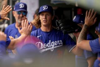 Los Angeles Dodgers starting pitcher Tyler Glasnow is greeted by teammates after being relieved.