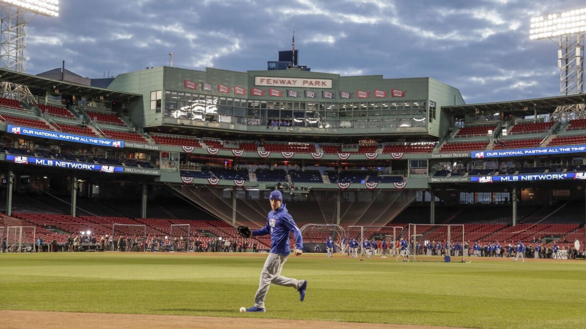 Dodgers outfielder Cody Bellinger practices fielding a ball coming off the center-field wall a day before Game 1 of the 2018 World Series at Fenway Park.