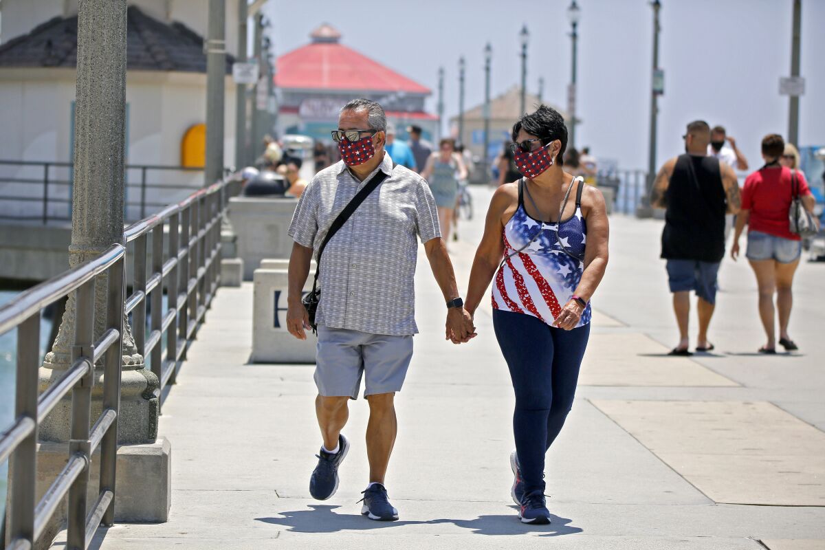 Danny Lopez of Chino Hills and his date Frances Pluma of Norwalk stroll on in Huntington Beach 