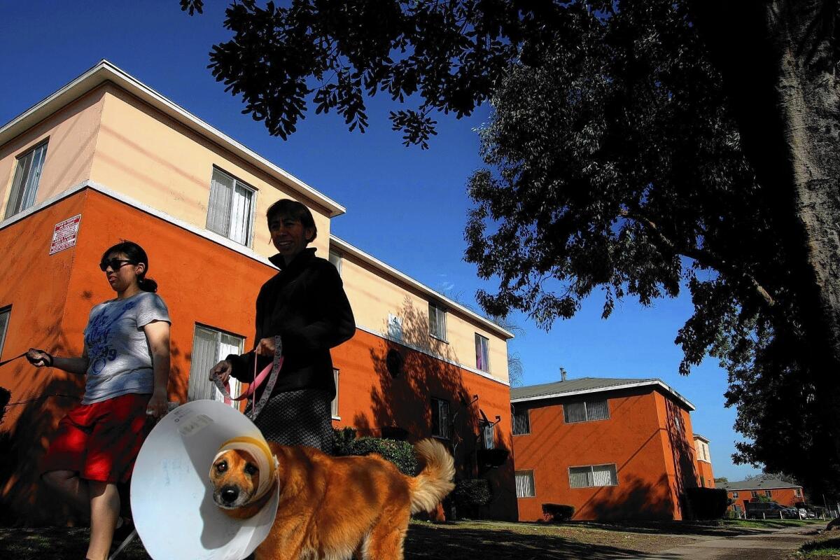 Women walk dogs in front of the Wyvernwood Garden Apartments in Boyle Heights. Built in 1939 and home to about 6,000 residents, the property is one of several considered endangered by the L.A. Conservancy.