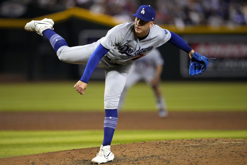 Dodgers pitcher Bobby Miller leans forward and delivers a throw from the mound against the Arizona Diamondbacks 