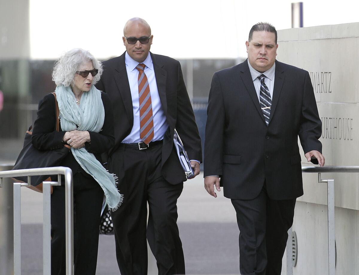 Former Navy Cmdr. Jose Luis Sanchez, right, arrives at federal court
