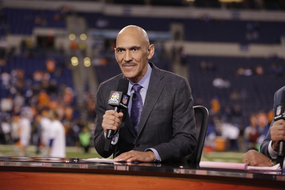 Analyst Tony Dungy talks on set before an NFL football game.