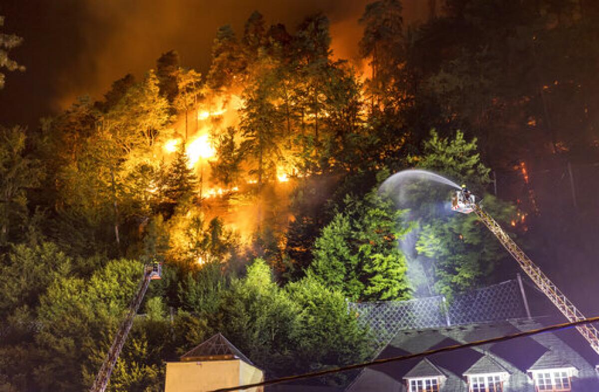 Firefighters throw water on fire 