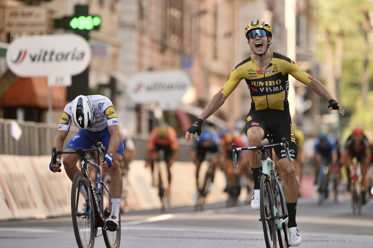 Belgium's Wout Van Aert, right, sprints ahead of France's Julian Alaphilippe to win the Milan to Sanremo cycling race, in San Remo, Italy, Saturday, Aug. 8, 2020. (Marco Alpozzi/LaPresse via AP)