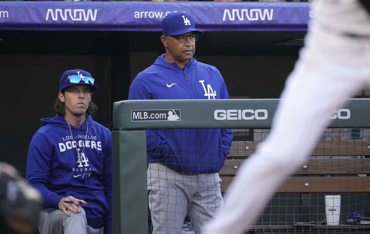 Dodgers manager Dave Roberts looks on.