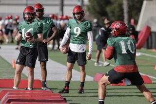 SAN DIEGO, CA - MARCH 12, 2024: Quarterbacks, from left, Danny O'Neil, Javance Tupou´ata-Johnson, and Kyle Crum, watch AJ Duffy throw a pass during Aztecs spring football practice at SDSU in San Diego on Tuesday, March 12, 2024. (Hayne Palmour IV / For The San Diego Union-Tribune)