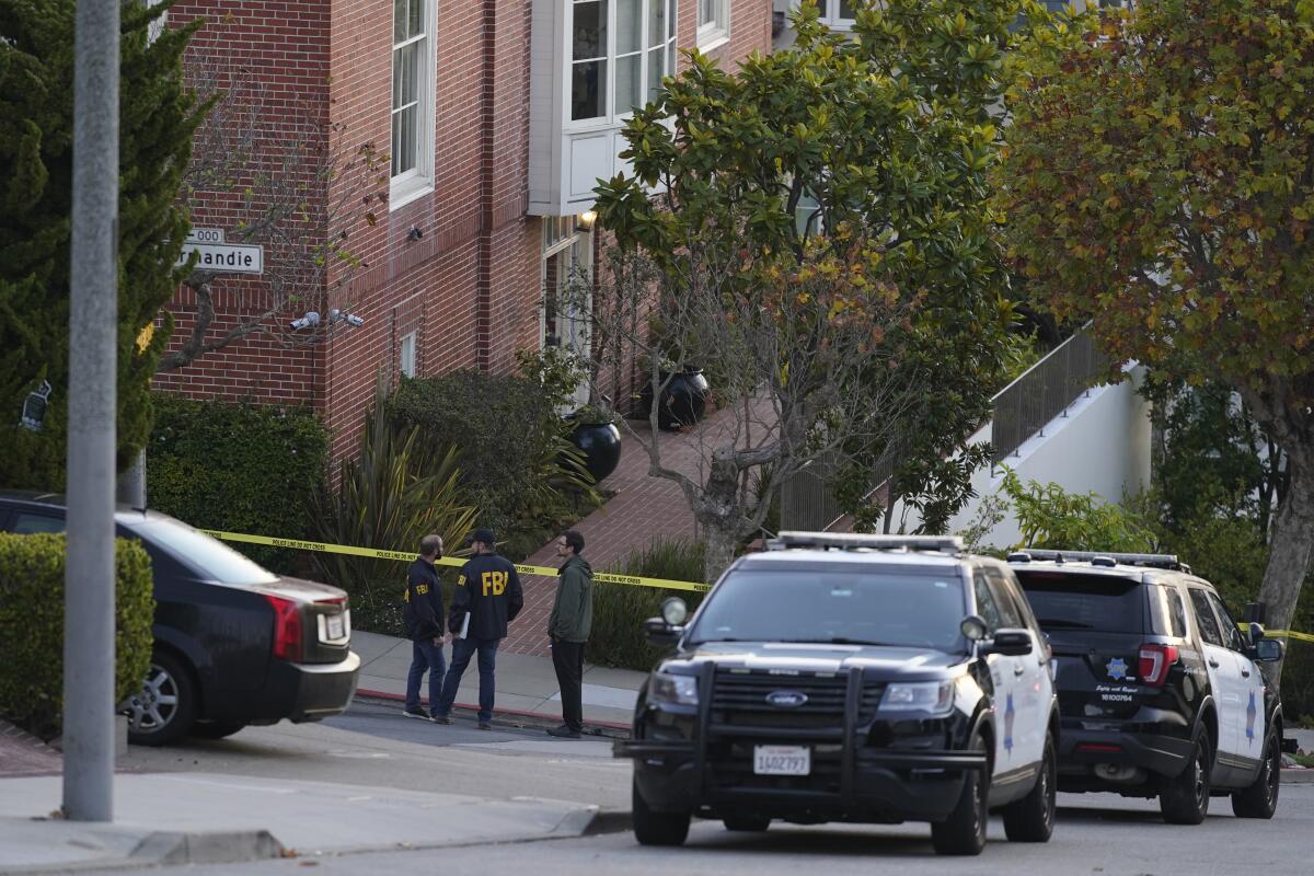 FBI agents and police SUVs outside a home surrounded by yellow crime scene tape