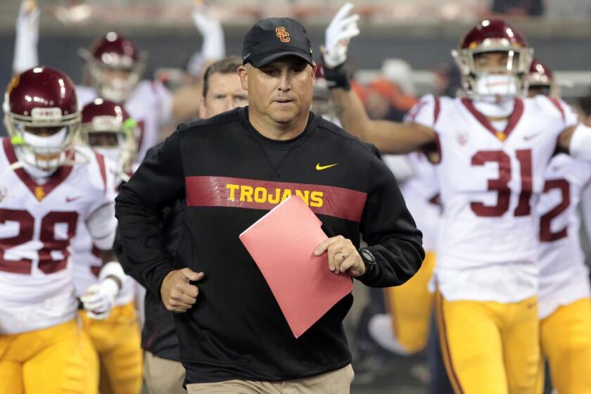 FILE - In this Nov. 3, 2018, file photo, Southern California head coach Clay Helton leads his team onto the field before an NCAA college football game in Corvallis, Ore. Some traditional recruiting heavyweights have plenty of work to do in the next several weeks to sign the level of talent they usually attract each year. As college footballs early signing period concluded Friday, Dec. 21, 2018, Southern California was outside the top 20 and Miami wasnt in the top 30 of the team standings in composite rankings of recruiting sites compiled by 247Sports. (AP Photo/Timothy J. Gonzalez, File)