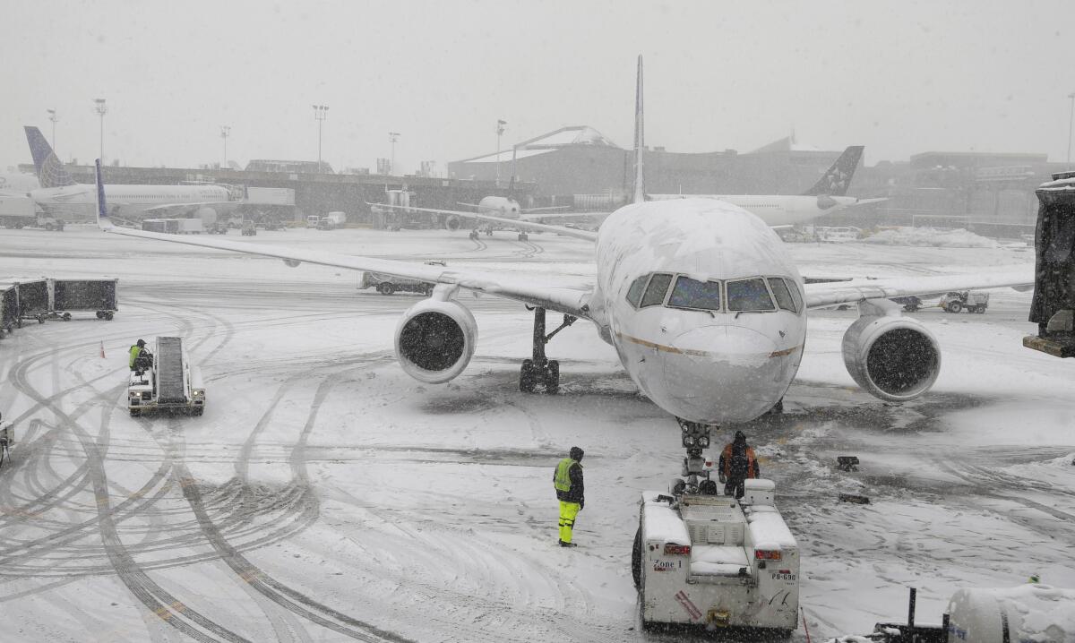 A United Airlines airplane is prepared to be pushed back from a gate on Monday at Newark Liberty International Airport in Newark, N.J. A winter storm one day after the Super Bowl canceled or delayed dozens of flights in the region.