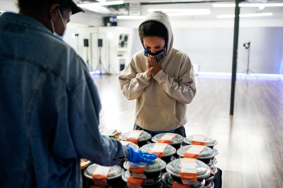 Kaileigh Williams of North Hollywood selects a meal from Everytable during a meal giveaway at KreativMndz Dance Academy.