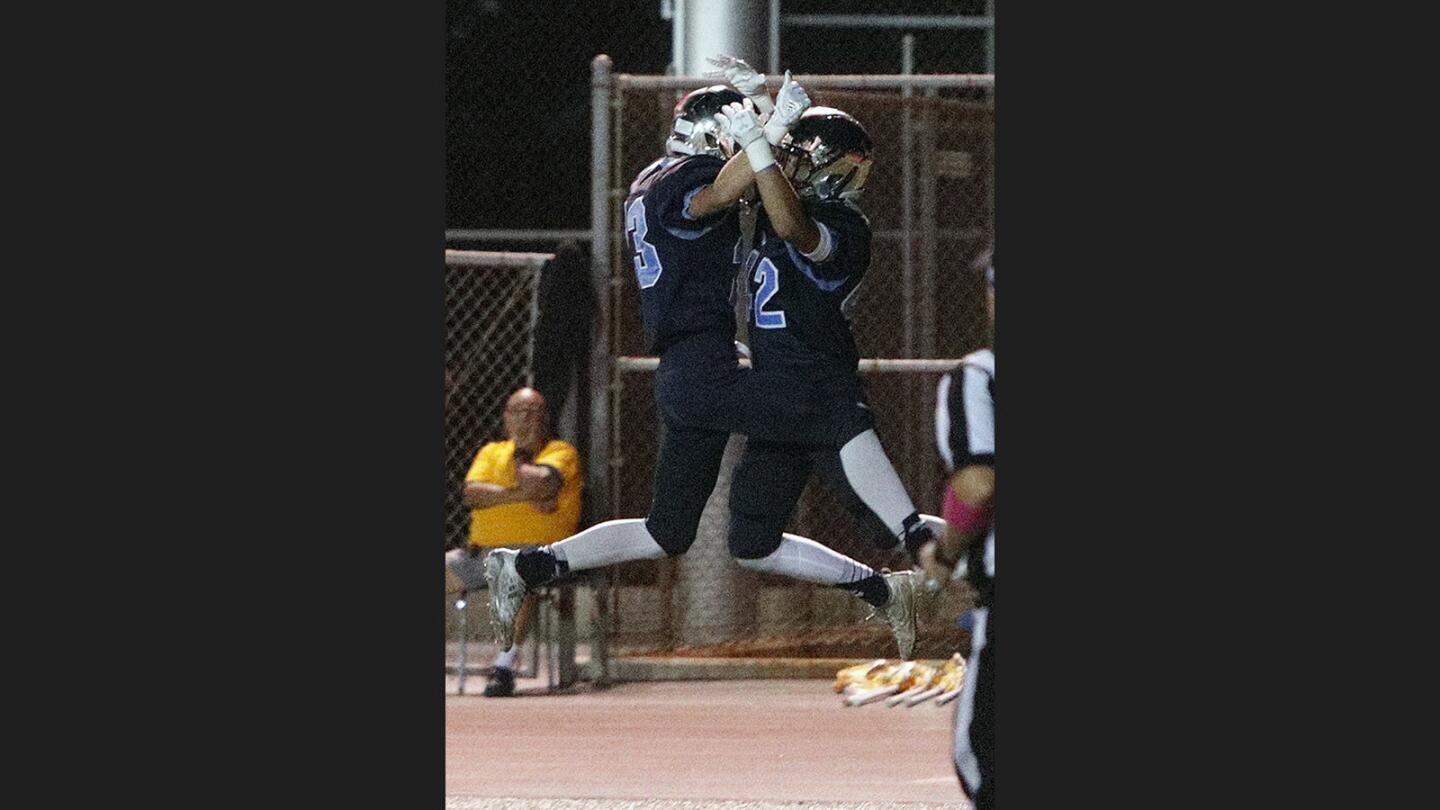 Crescenta Valley's Colby Rees runs to celebrate the touchdown by teammate Crescenta Valley's Vincent Parrott after a catch and run against Glendale in a Pacific League football game at Glendale High School on Friday, October 27, 2017.