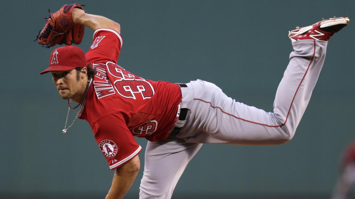 Angels starter C.J. Wilson delivers a pitch during the first inning of Monday's game against the Boston Red Sox.