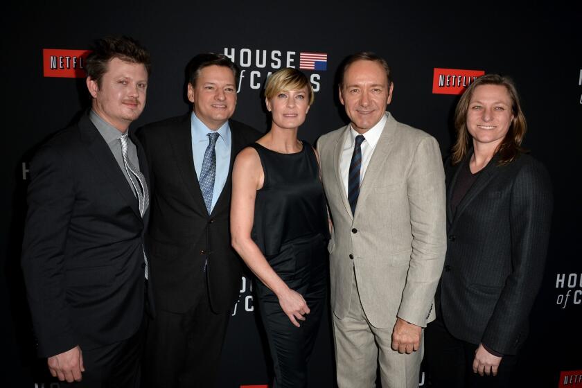Netflix and Comcast have reached an agreement that will ensure subscribers to the online video service will receive seamless access to TV shows and movies, like the original series "House of Cards." The second season of the political thriller debuted on Valentine's Day. From left, writer Beau Willimon, Netflix chief content officer Ted Sarandos, actress Robin Wright, executive producer/actor Kevin Spacey and Netflix vice president for original series Cindy Holland arrive at the special screening at the Directors Guild of America in Los Angeles.
