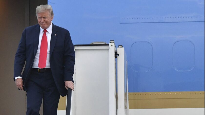 U.S. President Donald Trump disembarks Air Force One as he arrives in Melsbroek, Belgium.