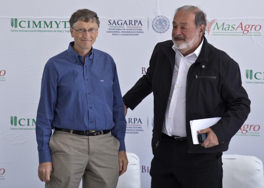 The world's two richest people, Mexican tycoon Carlos Slim, right, and Microsoft founder Bill Gates, speak at the inauguration of the International Maize and Wheat Improvement Center, built with funds from their foundations, in Texcoco, Mexico.