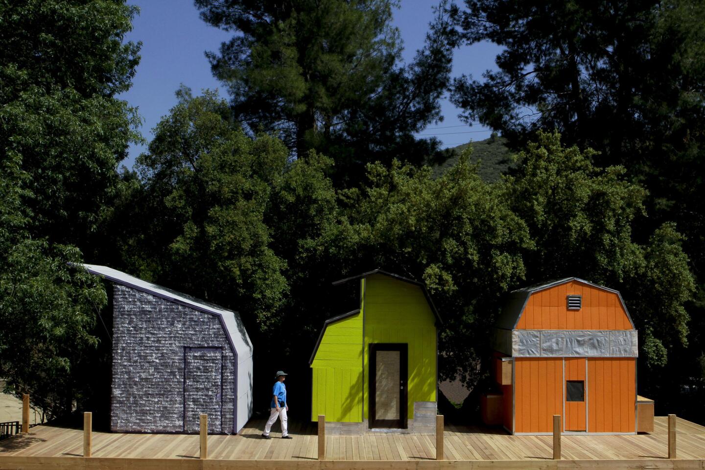 By Lisa Boone Woodbury architecture students transformed 10-by-10-foot sheds into clever and colorful accommodations set up at the Shadow Hills Riding Club equestrian center. The sheds had to be tweaked to provide light, ventilation, insulation and sleeping space for two. And though the teams each had a budget of $1,500 for additional supplies, they also had a mandate to experiment with one assigned material. Pictured here are the cabins from the plastic team, left, the wood team and the paper team.