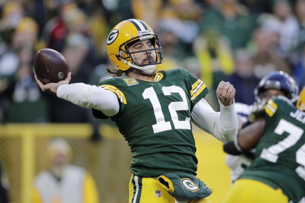 Green Bay Packers' Aaron Rodgers thorws during the first half of an NFL football game against the Seattle Seahawks Sunday, Nov. 14, 2021, in Green Bay, Wis. (AP Photo/Aaron Gash)