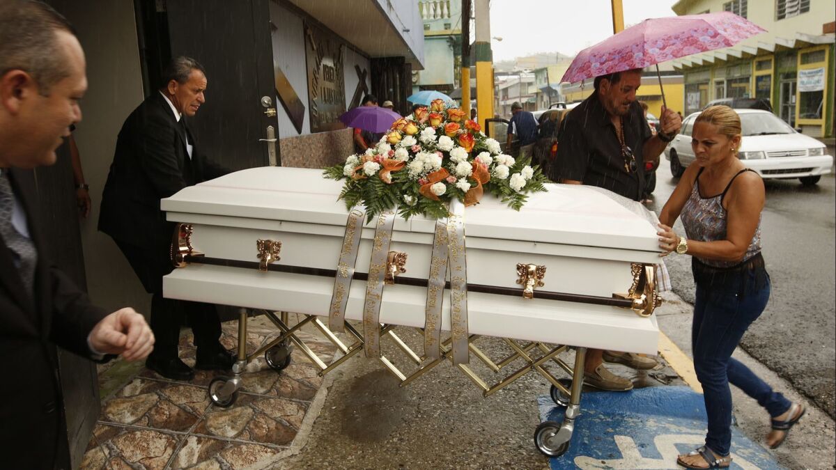 A funeral is held shortly after Hurricane Maria hit Puerto Rico in September 2017. The official estimated death toll is 64, but a new analysis finds the true figure could be 70 times higher.