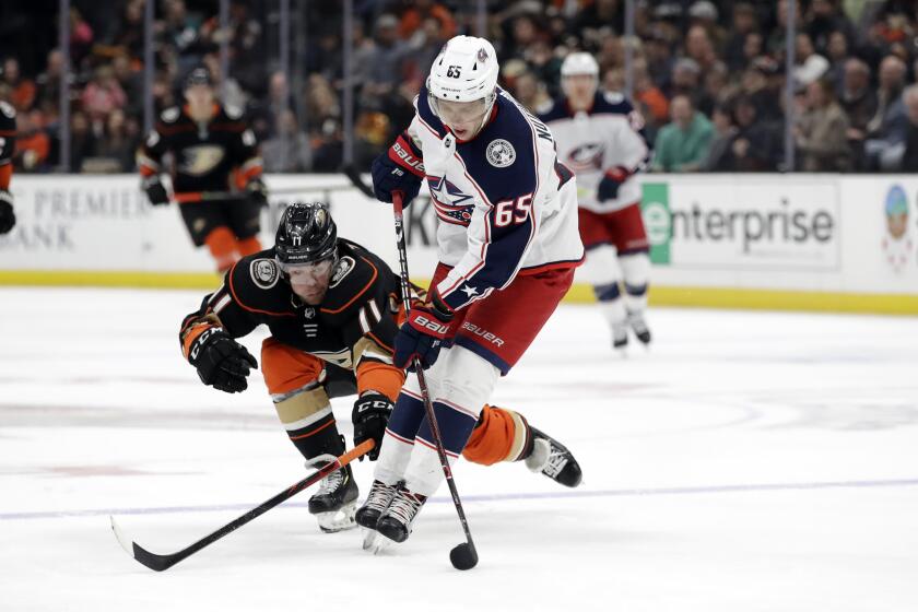Columbus Blue Jackets' Markus Nutivaara, right, controls the puck next to Anaheim Ducks' Daniel Sprong (11) during the second period of an NHL hockey game Tuesday, Jan. 7, 2020, in Anaheim, Calif. (AP Photo/Marcio Jose Sanchez)