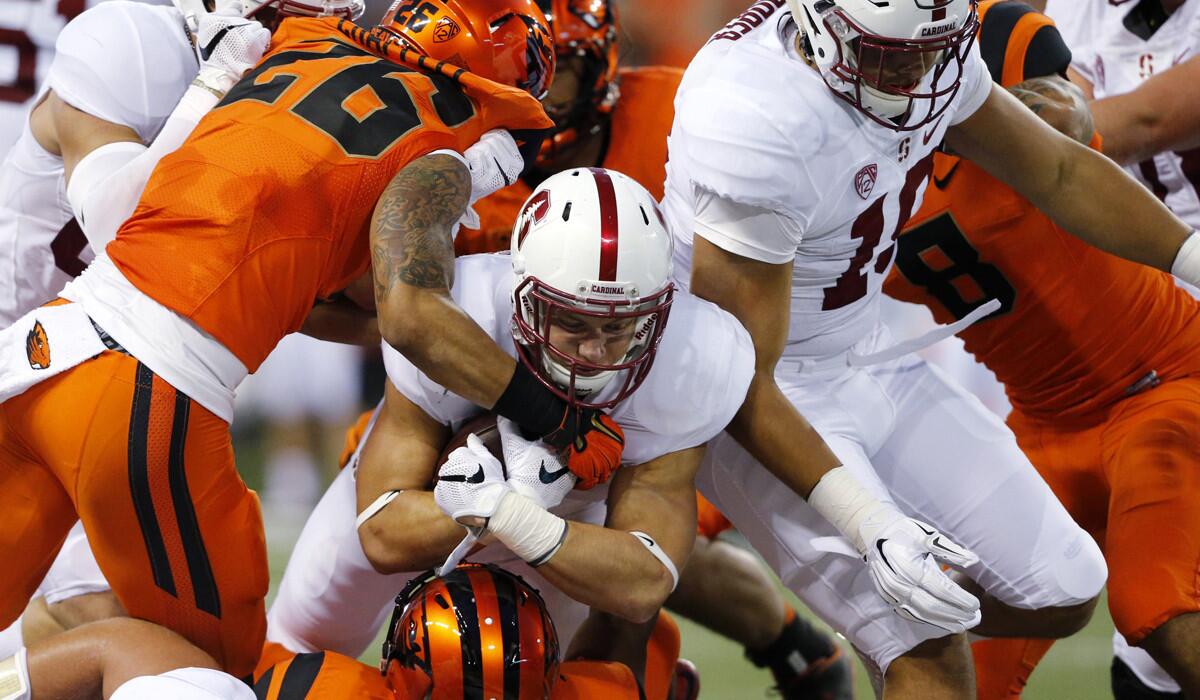 Stanford's Christian McCaffrey, center, is tackled by Oregon State'defenders during the first half on Friday.