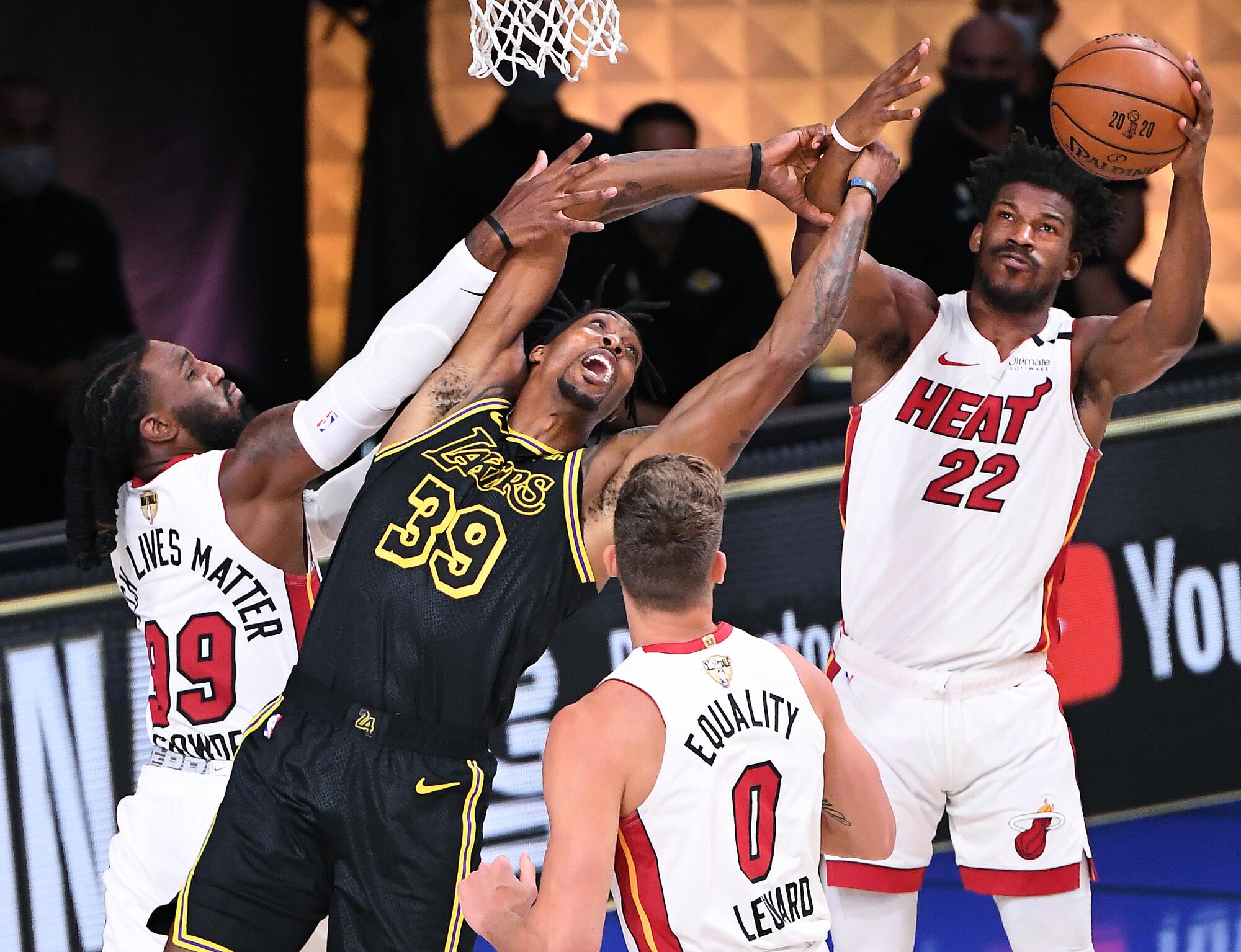 Lakers center Dwight Howard battles for a rebound with Miami's Jae Crowder, left, and Jimmy Butler.