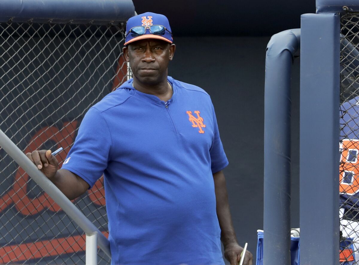 FILE - In this Monday, Feb. 25, 2019, file photo, New York Mets hitting coach Chili Davis watches from the top of the dugout steps during the fifth inning of an exhibition spring training baseball game against the Houston Astros in West Palm Beach, Fla. Late Monday, May 3, 2021, the Mets fired Davis and assistant hitting coach Tom Slater. (AP Photo/Jeff Roberson, File)