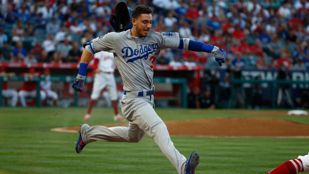 The Dodgers' Cody Bellinger loses his helmet running against the Angels at Angel Stadium on Monday.