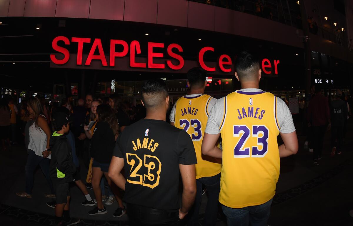 Fans wearing LeBron James jerseys head into Staples Center before the Lakers-Houston Rockets game on Oct. 20, 2018.