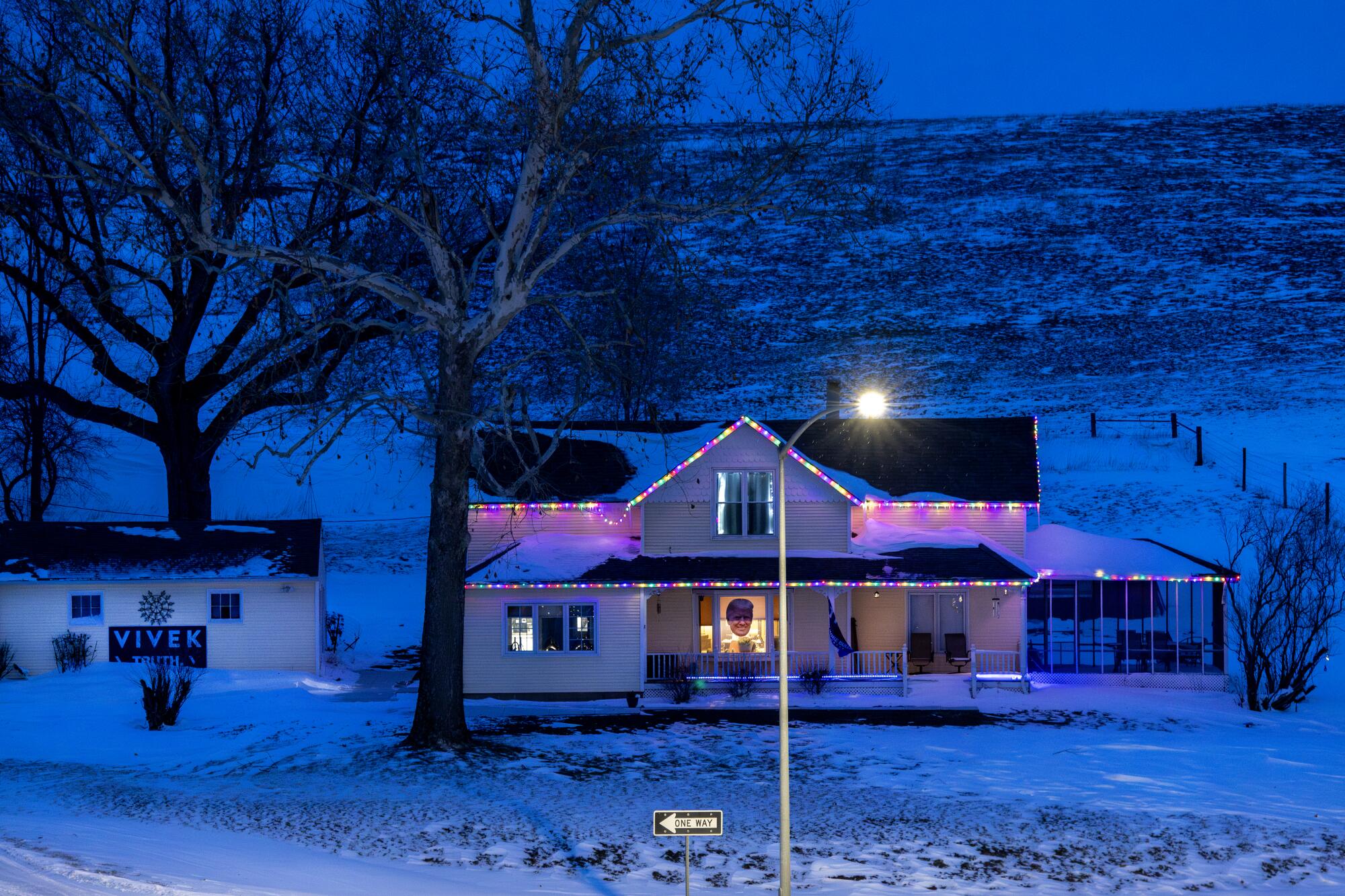 A rural home near a snowy hill 