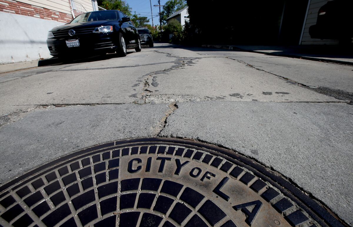 A concrete street in Mount Washington is lined with deep rifts, uneven patches and long cracks. The area has some of the worst streets in Los Angeles.