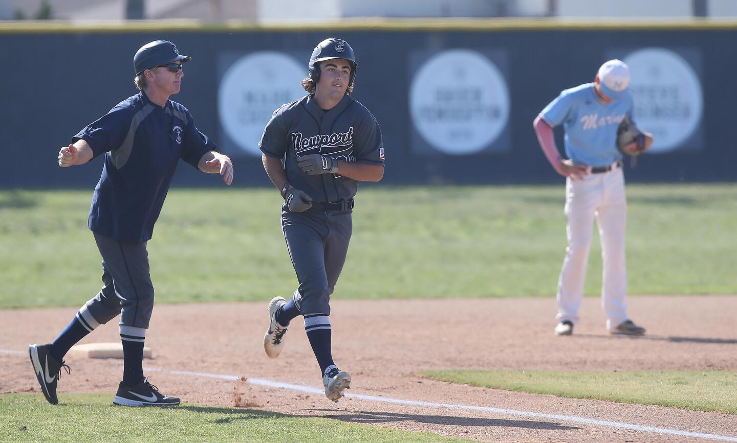 Newport Harbor's Jack Bibb rounds third after hitting a two-run homer in a Wave League game at Marina on Tuesday.