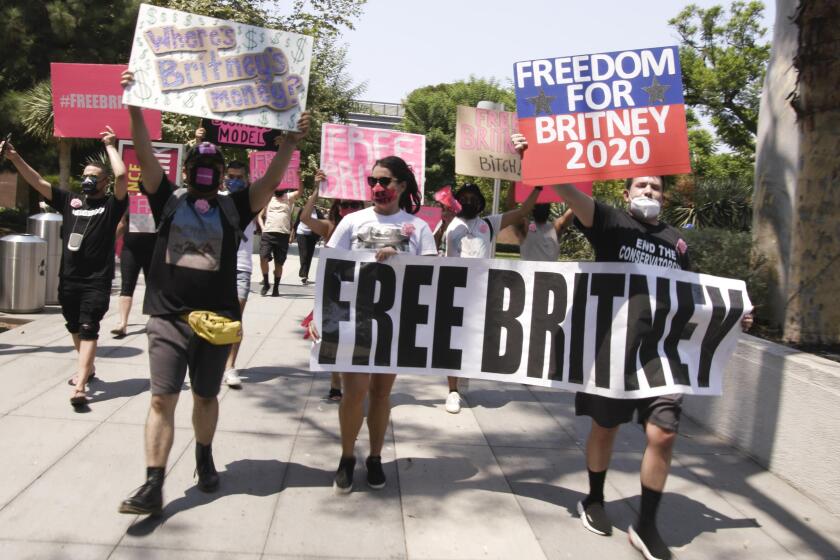 #FreeBritney activists hold signs and march near the Stanley Mosk courthouse where a conservatorship hearing for Britney Spears is being held.