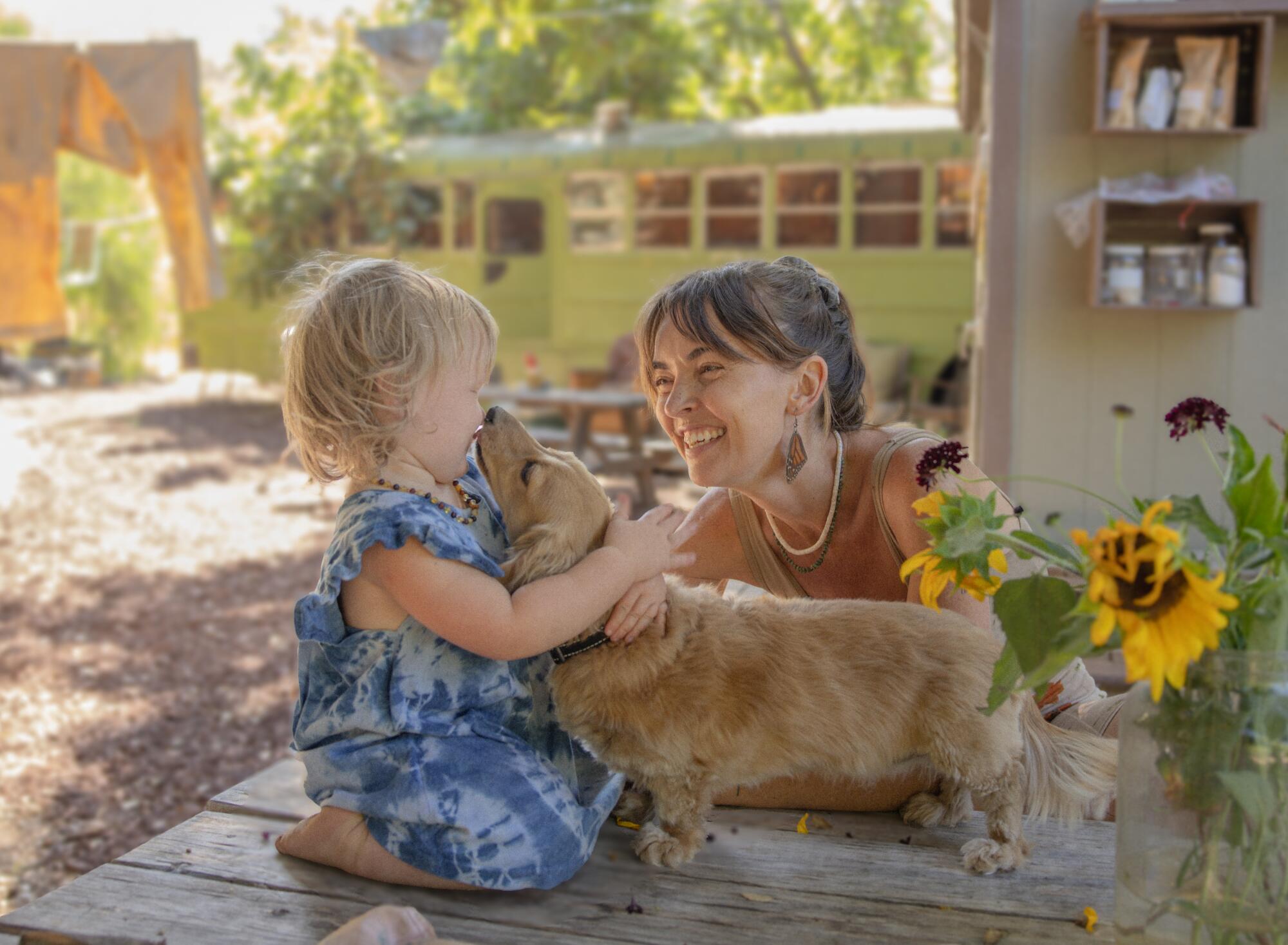 Laura La Rue at home with her 16-month-old daughter Lasca and dog, June Carter.